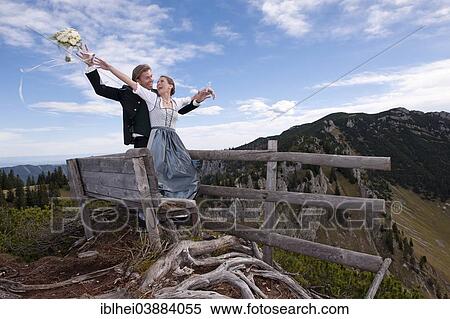 "Wedding couple on a mountain throwing the bridal bouquet, Mt Spitzplaneck, Almtal Valley, Upper Austria, Austria, Europe" View Large Photo Image Stock Photography - "Wedding couple on a mountain throwing the bridal bouquet, Mt Spitzplaneck, Almtal Valley, Upper Austria, Austria, Europe". Fotosearch