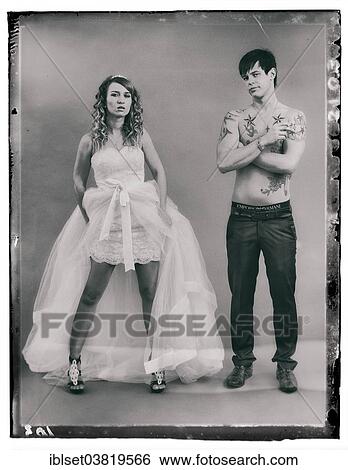 "Wedding picture, a bride in a short dress and a bare chested groom with tattoos, holding a cigarette" View Large Photo Image Stock Photograph - "Wedding picture, a bride in a short dress and a bare chested groom with tattoos, holding a cigarette". Fotosearch