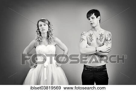 Stock Photo - "Wedding picture, bride and groom, bare chested groom with tattoos and a cigarette". Fotosearch