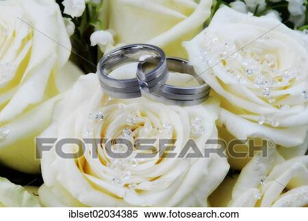 Wedding rings on white roses with crystals View Large Photo Image Stock Photography - Wedding rings on white roses with crystals. Fotosearch