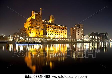 Stock Photo - "Werhahnmuhle, former mill, and the """"Faktorei 21"""" building, at night, Innenhafen, Inner Harbour, Duisburg, Ruhr Area, North Rhine-Westphalia, Germany, Europe". Fotosearch