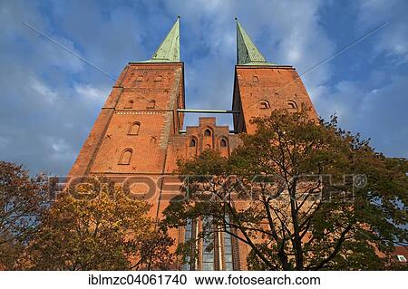 Stock Image - "West towers of Lubeck Cathedral in the evening light, consecrated in 1247, red brick construction, 1266-1335 rebuilt into a Gothic hall church, Lubeck, Schleswig-Holstein, Germany, Europe". Fotosearch