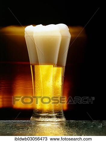 Stock Image - "Wheat beer, beer glass, motion blur". Fotosearch