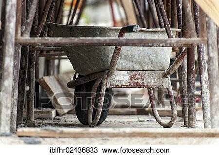 "Wheelbarrow standing under scaffolding, Grevenbroich, North Rhine-Westphalia, Germany, Europe" View Large Photo Image Stock Image - "Wheelbarrow standing under scaffolding, Grevenbroich, North Rhine-Westphalia, Germany, Europe". Fotosearch
