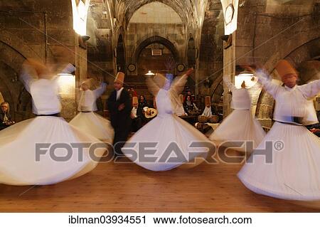 Stock Image - "Whirling Dervishes of the Mevlevi Order, Sema ceremony, Saruhan Caravanserai, Sarihan, near Avanos, Cappadocia, Central Anatolia Region, Anatolia, Turkey, Asia". Fotosearch