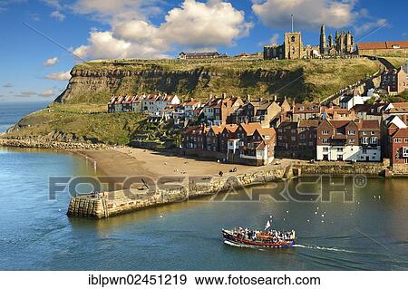 Stock Photo - "Whitby harbour with Whitby Abbey on the headland, Whitby, North Yorkshire, England, United Kingdom, Europe". Fotosearch