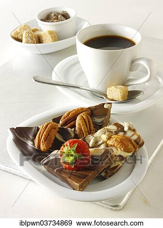 "White and milk chocolate swirls with strawberries, pecan nuts and coffee" View Large Photo Image Stock Photo - "White and milk chocolate swirls with strawberries, pecan nuts and coffee". Fotosearch