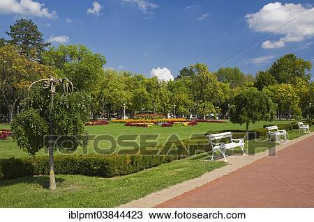 "White benches along the boardwalk in the park at Lake Palic, near Subotica, Serbia, Europe" View Large Photo Image Stock Image - "White benches along the boardwalk in the park at Lake Palic, near Subotica, Serbia, Europe". Fotosearch