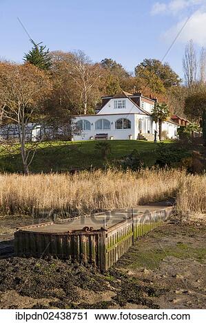 "White chalet bungalow with its own jetty on the River Hamble estuary at low tide, England, United Kingdom, Europe" View Large Photo Image Stock Image - "White chalet bungalow with its own jetty on the River Hamble estuary at low tide, England, United Kingdom, Europe". Fotosearch
