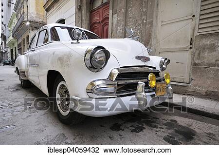 Stock Image - "White classic car, historic centre, Havana, Ciudad de La Habana, Cuba, North America". Fotosearch