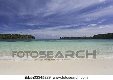 "White sand beach, shallow turquoise water and a light cloud streaked sky, Ile des Pins, New Caledonia, France, Oceania" View Large Photo Image Stock Photo - "White sand beach, shallow turquoise water and a light cloud streaked sky, Ile des Pins, New Caledonia, France, Oceania". Fotosearch