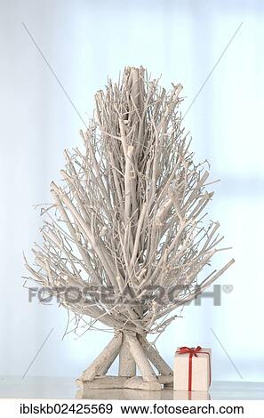 White tree made of twigs with a gift View Large Photo Image Stock Photo - White tree made of twigs with a gift. Fotosearch