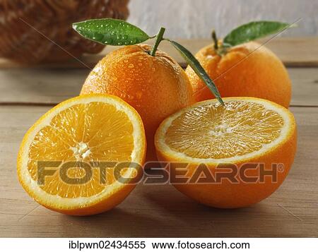Stock Photography - Whole and cut fresh oranges. Fotosearch
