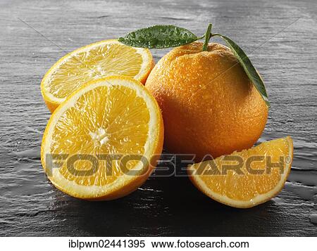 Stock Photography - Whole and cut fresh oranges. Fotosearch