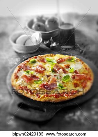 Stock Image - Whole prosciutto pizza. Fotosearch