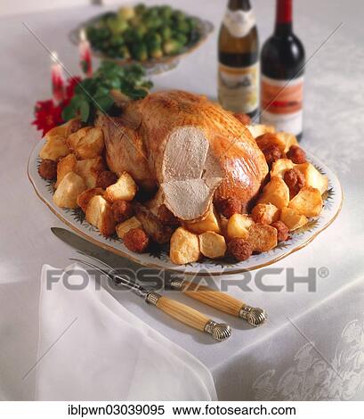 Whole roast turkey on a platter with roast potatoes View Large Photo Image Stock Photography - Whole roast turkey on a platter with roast potatoes. Fotosearch