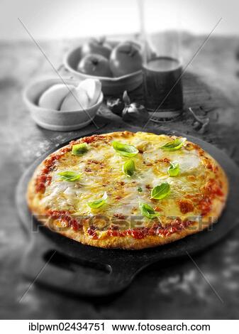 Whole thin crust cheese and tomato pizza View Large Photo Image Stock Image - Whole thin crust cheese and tomato pizza. Fotosearch