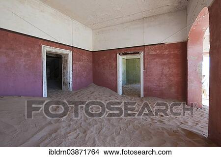 "Wind-borne sand in a house of the former diamond miners settlement that is slowly covered by the sand of the Namib Desert, Kolmanskop, ÇKaras, Namibia, Africa" View Large Photo Image Picture - "Wind-borne sand in a house of the former diamond miners settlement that is slowly covered by the sand of the Namib Desert, Kolmanskop, ÇKaras, Namibia, Africa". Fotosearch