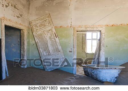 "Wind-borne sand in a house of the former diamond miners settlement that is slowly covered by the sand of the Namib Desert, Kolmanskop, ÇKaras, Namibia, Africa" View Large Photo Image Stock Image - "Wind-borne sand in a house of the former diamond miners settlement that is slowly covered by the sand of the Namib Desert, Kolmanskop, ÇKaras, Namibia, Africa". Fotosearch
