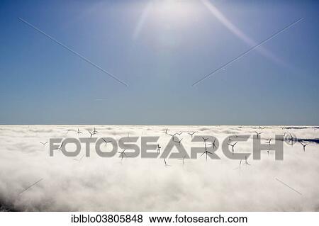 "Wind turbines covered by low clouds, blue sky, aerial view, Marsberg, Sauerland region, North Rhine-Westphalia, Germany, Europe" View Large Photo Image Stock Photo - "Wind turbines covered by low clouds, blue sky, aerial view, Marsberg, Sauerland region, North Rhine-Westphalia, Germany, Europe". Fotosearch