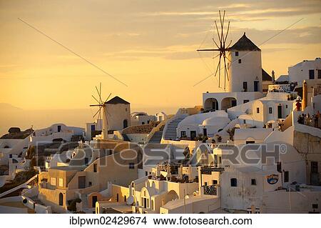 Picture - "Windmills and town at sunset, Oia, Ia, Santorini, Cyclades Islands, Greece, Europe". Fotosearch