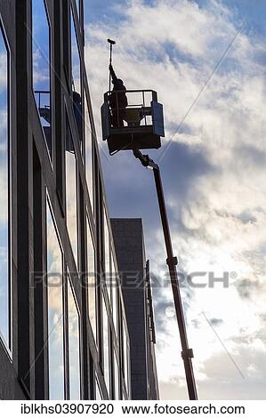 Stock Image - "Window cleaner cleaning the windows of a hotel, Berlin, Germany, Europe". Fotosearch