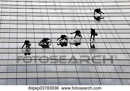 Window cleaners cleaning a glass facade View Large Photo Image Stock Photograph - Window cleaners cleaning a glass facade. Fotosearch
