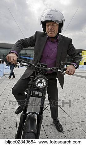 "Winfried Hermann, Baden-Wuerttemberg's Minister of Transport and Infrastructure riding an E-Bike or electric bike in Stuttgart, Baden-Wuerttemberg, Germany, Europe" View Large Photo Image Picture - "Winfried Hermann, Baden-Wuerttemberg's Minister of Transport and Infrastructure riding an E-Bike or electric bike in Stuttgart, Baden-Wuerttemberg, Germany, Europe". Fotosearch