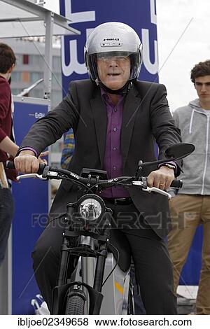 "Winfried Hermann, Baden-Wuerttemberg's Minister of Transport and Infrastructure only riding a bicycle wearing a helmet, Stuttgart, Baden-Wuerttemberg, Germany, Euro, Europe" View Large Photo Image Stock Photo - "Winfried Hermann, Baden-Wuerttemberg's Minister of Transport and Infrastructure only riding a bicycle wearing a helmet, Stuttgart, Baden-Wuerttemberg, Germany, Euro, Europe". Fotosearch
