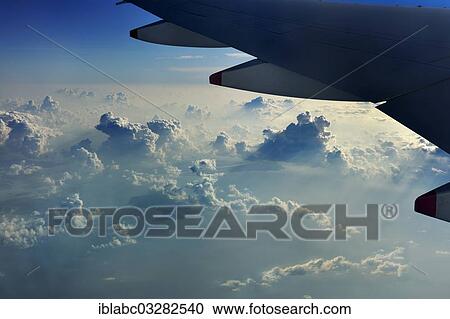 "Wing of a plane with clouds, Singapore, Singapore, Asia" View Large Photo Image Stock Image - "Wing of a plane with clouds, Singapore, Singapore, Asia". Fotosearch