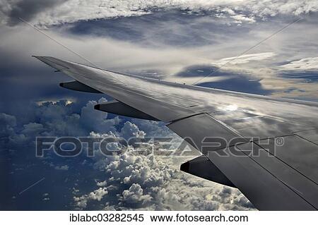 "Wing of a plane with clouds, Indonesia, Asia" View Large Photo Image Stock Photography - "Wing of a plane with clouds, Indonesia, Asia". Fotosearch