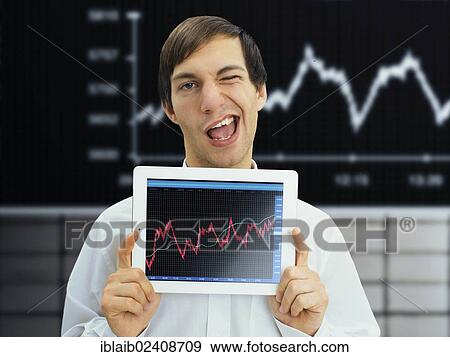 Stock Photo - "Winking businessman holding an iPad with a rising stock chart, symbolic image for economy, growth, economic recovery". Fotosearch