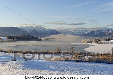 "Winter landscape, Lake Riegsee in front of Estergebirge mountains, Wetterstein range and Ammergau Alps with Ettaler Mandl peak, Murnau, Pfaffenwinkel region, Upper Bavaria, Germany, Europe" View Large Photo Image Stock Photograph - "Winter landscape, Lake Riegsee in front of Estergebirge mountains, Wetterstein range and Ammergau Alps with Ettaler Mandl peak, Murnau, Pfaffenwinkel region, Upper Bavaria, Germany, Europe". Fotosearch
