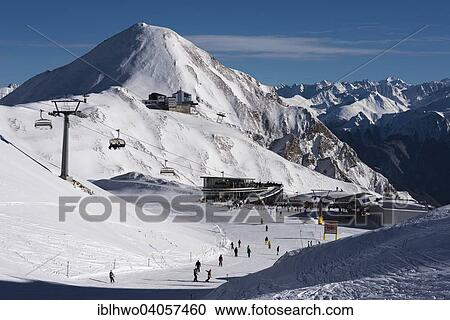 "Winter sports region Silvretta Arena, Ischgl-Samnaun, Restaurant Saalas and cable car stations, behind large cable car station Alp Trida Sattel and Swiss Alps, Samnaun, Graubunden, Austria, Europe" View Large Photo Image Stock Image - "Winter sports region Silvretta Arena, Ischgl-Samnaun, Restaurant Saalas and cable car stations, behind large cable car station Alp Trida Sattel and Swiss Alps, Samnaun, Graubunden, Austria, Europe". Fotosearch