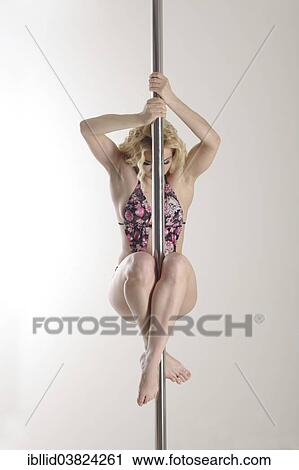 "Woman, 24 years, pole dancing" View Large Photo Image Stock Image - "Woman, 24 years, pole dancing". Fotosearch