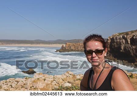 Stock Image - "Woman, 25, smiling, Praia da Bordeira, Carrapateira, Algarve, West Coast, Portugal, Atlantic, Europe". Fotosearch