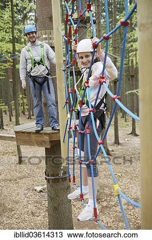 "Woman, 36, climbing in front of her husband in a climbing park, Svaty Linhart, Karlovy Vary, Karlovy Vary Region, Bohemia, Czech Republic, Europe" View Large Photo Image Stock Image - "Woman, 36, climbing in front of her husband in a climbing park, Svaty Linhart, Karlovy Vary, Karlovy Vary Region, Bohemia, Czech Republic, Europe". Fotosearch
