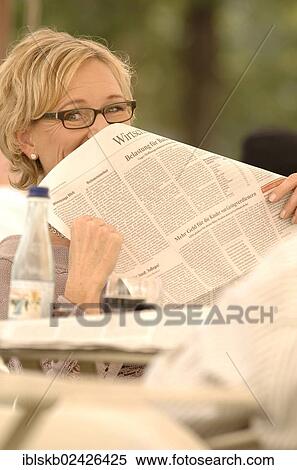 "Woman, 40-50 years, her face half hidden behind a newspaper" View Large Photo Image Stock Photography - "Woman, 40-50 years, her face half hidden behind a newspaper". Fotosearch