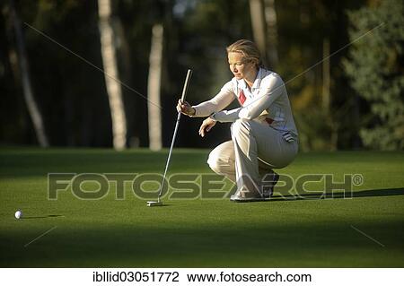 Stock Image - "Woman, 41, playing golf on a golf course, golf resort, Karlovy Vary, Karlovy Vary Region, Bohemia, Czech Republic, Europe". Fotosearch
