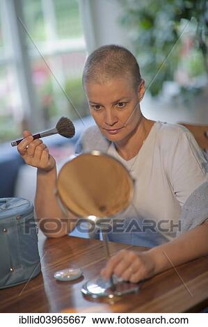 "Woman, 48 years old, with short hair after chemotherapy, applying makeup" View Large Photo Image Stock Photo - "Woman, 48 years old, with short hair after chemotherapy, applying makeup". Fotosearch