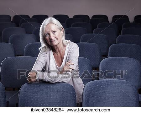 "Woman, 65-75 years, sitting in a small concert hall, Telfs, Innsbruck, Tyrol" View Large Photo Image Picture - "Woman, 65-75 years, sitting in a small concert hall, Telfs, Innsbruck, Tyrol". Fotosearch