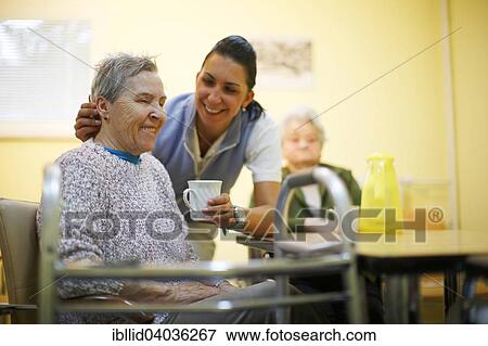 Stock Photo - "Woman, 79 years, in a nursing home, at breakfast, supported by a geriatric nurse, Kralovske Porici, Bohemia, Czech Republic, Europe". Fotosearch