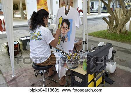 "Woman airbrushing a portrait on a T-shirt, Hua Hin, Thailand, Asia" View Large Photo Image Stock Photography - "Woman airbrushing a portrait on a T-shirt, Hua Hin, Thailand, Asia". Fotosearch