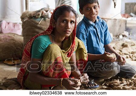 "Woman and a boy sorting roots, spice market, Old Dhaka, Dhaka, Bangladesh, South Asia, Asia" View Large Photo Image Stock Photo - "Woman and a boy sorting roots, spice market, Old Dhaka, Dhaka, Bangladesh, South Asia, Asia". Fotosearch