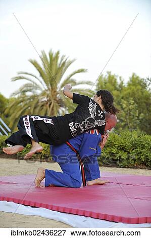 Woman and a man doing martial arts training in a park View Large Photo Image Stock Photo - Woman and a man doing martial arts training in a park. Fotosearch