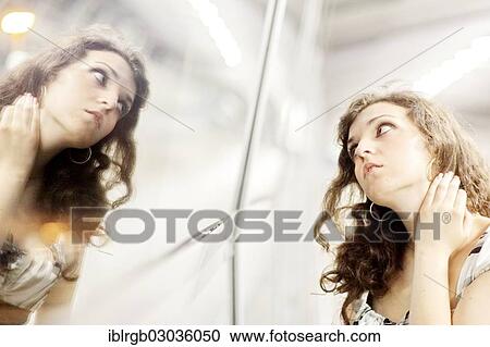 Stock Image - "Woman and her mirror image, Allgaeu, Kempten, Allgau, Swabia, Bavaria, Germany, Europe". Fotosearch