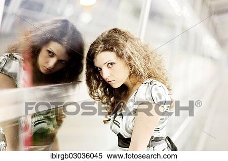 Stock Photography - "Woman and her mirror image, Allgaeu, Kempten, Allgau, Swabia, Bavaria, Germany, Europe". Fotosearch