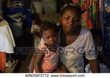 Stock Image - "Woman and little girl, two years, in a shack, Camp Icare for earthquake refugees, Fort National, Port-au-Prince, Haiti, North America". Fotosearch
