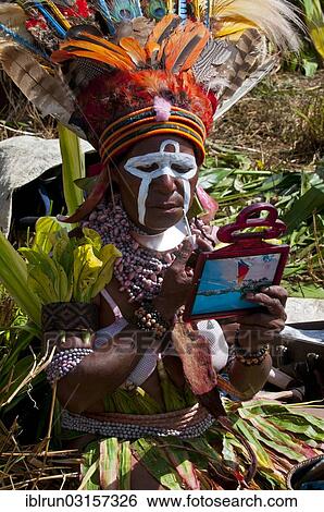 "Woman applying make-up or face paint at the traditional sing-sing gathering, Hochland, Mount Hagen, Western Highlands Province, Papua New Guinea, Oceania" View Large Photo Image Stock Photograph - "Woman applying make-up or face paint at the traditional sing-sing gathering, Hochland, Mount Hagen, Western Highlands Province, Papua New Guinea, Oceania". Fotosearch
