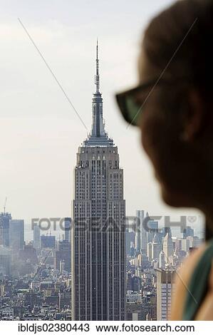 "Woman at a window of the Rockefeller Center with views of the Empire State Building, Manhattan, New York, USA" View Large Photo Image Stock Image - "Woman at a window of the Rockefeller Center with views of the Empire State Building, Manhattan, New York, USA". Fotosearch